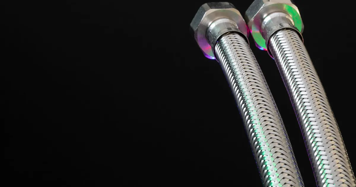 Braided stainless hose ends with hex nuts, the type of fitting that screws into a machined AN port